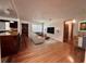 Cozy living room with hardwood floors, and an adjacent modern kitchen with a breakfast bar at 1951 S Crystal Lake Dr, Orlando, FL 32806