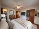 Bedroom features soft natural light, ceiling fan, and ensuite bathroom at 1951 S Crystal Lake Dr, Orlando, FL 32806