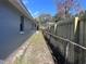 View of side yard featuring the exterior wall of the home with a new privacy fence at 1951 S Crystal Lake Dr, Orlando, FL 32806