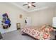 Bedroom with floral bedding, ceiling fan, and dresser at 310 Villa Sorrento Cir, Haines City, FL 33844