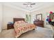 Bedroom with floral bedding, ceiling fan, and dresser at 310 Villa Sorrento Cir, Haines City, FL 33844