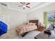 Bedroom with floral bedding, ceiling fan, and dresser at 310 Villa Sorrento Cir, Haines City, FL 33844