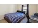 Bright bedroom with striped bedding, workspace, and window coverings at 310 Villa Sorrento Cir, Haines City, FL 33844