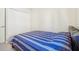 Bedroom with striped bedding and double doors to closet at 310 Villa Sorrento Cir, Haines City, FL 33844