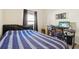 Bedroom with striped bedding, workspace, and window coverings at 310 Villa Sorrento Cir, Haines City, FL 33844
