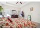 Bedroom with floral bedding, ceiling fan, and dresser at 310 Villa Sorrento Cir, Haines City, FL 33844