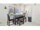 Kitchen breakfast nook with dark wood table and black leather chairs at 310 Villa Sorrento Cir, Haines City, FL 33844