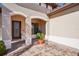 Front entry with arched entryway, and a potted plant at 310 Villa Sorrento Cir, Haines City, FL 33844