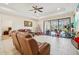 Bright living room with leather furniture and access to backyard pool at 310 Villa Sorrento Cir, Haines City, FL 33844