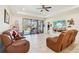 Spacious living room with leather recliners and view of the pool at 310 Villa Sorrento Cir, Haines City, FL 33844