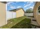 Backyard featuring green grass, white fences, a patio, and exterior walls at 409 Horizon Dr, Winter Springs, FL 32708