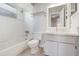 This bathroom offers a shower-tub combo, neutral walls, standard toilet, and vanity with sink at 409 Horizon Dr, Winter Springs, FL 32708