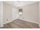 Bright bedroom with wood-look flooring, window and double door closet at 409 Horizon Dr, Winter Springs, FL 32708