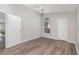This bedroom features neutral walls, wood-look floors, natural light from arched window and closet at 409 Horizon Dr, Winter Springs, FL 32708
