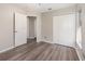 Neutral bedroom with wood-look flooring and double closet doors at 409 Horizon Dr, Winter Springs, FL 32708