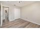 This bedroom features neutral walls, wood-look floors, closet, and an open doorway at 409 Horizon Dr, Winter Springs, FL 32708