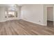 Spacious living room featuring wood-look flooring, large windows and neutral paint throughout at 409 Horizon Dr, Winter Springs, FL 32708