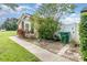 Side exterior view of a cozy home with manicured lawn, sidewalk, and a privacy fence at 409 Horizon Dr, Winter Springs, FL 32708