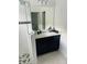 Clean bathroom with dark vanity, large mirror, and walk-in shower at 737 Trillium Ct, Debary, FL 32713
