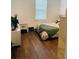 Bedroom with wood floors, side table and window with blinds at 737 Trillium Ct, Debary, FL 32713
