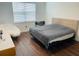 Bright bedroom with large bed, hardwood floors, and window at 737 Trillium Ct, Debary, FL 32713