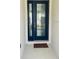 Modern entryway with a dark blue front door and a welcome mat at 737 Trillium Ct, Debary, FL 32713