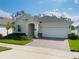 Single-story home with a two-car garage and landscaped lawn at 737 Trillium Ct, Debary, FL 32713