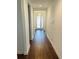 Long hallway with wood-look floors leading to other rooms at 737 Trillium Ct, Debary, FL 32713