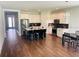 Modern kitchen with island, stainless steel appliances, and dark wood flooring at 737 Trillium Ct, Debary, FL 32713