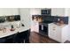 Modern kitchen with white cabinets and a large island at 737 Trillium Ct, Debary, FL 32713