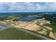 Aerial view of new home community with lake and many undeveloped lots at 16875 Muskgrass Dr, Winter Garden, FL 34787