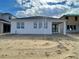 New construction home featuring a stucco exterior, large windows, and a covered lanai at 16875 Muskgrass Dr, Winter Garden, FL 34787