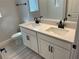 Bright bathroom with dual sink vanity, a white countertop, and modern black fixtures at 16875 Muskgrass Dr, Winter Garden, FL 34787