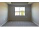 Sun-lit bedroom featuring plush carpet, a modern ceiling detail, and neutral wall paint at 16875 Muskgrass Dr, Winter Garden, FL 34787