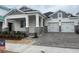 Two-story home with gray siding, stone accents, and a two-car garage at 16875 Muskgrass Dr, Winter Garden, FL 34787