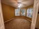Bright bedroom with three windows, neutral carpeting, and a ceiling fan at 284 Pinestraw Cir, Altamonte Springs, FL 32714