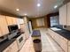 Well-lit kitchen with an island, white cabinetry, stainless steel appliances and tile floors at 284 Pinestraw Cir, Altamonte Springs, FL 32714