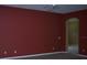 Living room featuring red walls and an arched doorway at 284 Pinestraw Cir, Altamonte Springs, FL 32714