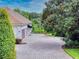 Brick paved driveway leading to a three-car garage at 1185 Coachwood Ct, Longwood, FL 32779