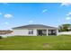 Expansive backyard with a covered patio, perfect for outdoor entertaining and relaxation at 1302 Belmar Ter, Deltona, FL 32725