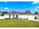 Charming single-story home with a well-manicured lawn, solar panels, and a two-car garage at 1302 Belmar Ter, Deltona, FL 32725