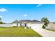 Charming one-story home with a well-manicured lawn and a two-car garage at 1302 Belmar Ter, Deltona, FL 32725