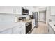Modern kitchen with stainless steel appliances, white cabinets, and quartz countertops at 1302 Belmar Ter, Deltona, FL 32725