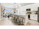 Bright, open kitchen with large island, stainless appliances, and adjacent dining area at 1302 Belmar Ter, Deltona, FL 32725