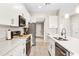Stylish kitchen featuring quartz counters, stainless appliances, and ample cabinet space at 1302 Belmar Ter, Deltona, FL 32725