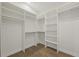 Large walk-in closet with custom shelving, clothing rods, and hardwood floors at 1919 S Lakemont Ave, Winter Park, FL 32792