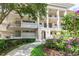 Exterior of condo building with landscaped grounds and walkway at 700 Melrose Ave J 1 Ave # J1, Winter Park, FL 32789