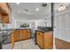 Kitchen with wood cabinets, black countertops, stainless steel appliances, and adjacent laundry area at 700 Melrose Ave J 1 Ave # J1, Winter Park, FL 32789
