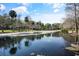 Peaceful pond reflecting the surrounding trees at 700 Melrose Ave J 1 Ave # J1, Winter Park, FL 32789