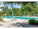 Community pool with lounge chairs and patio tables at 700 Melrose Ave J 1 Ave # J1, Winter Park, FL 32789